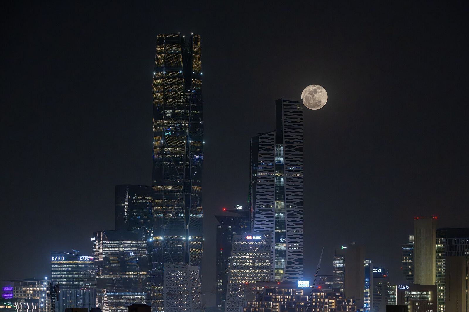 KAFD skyline at night with full moon