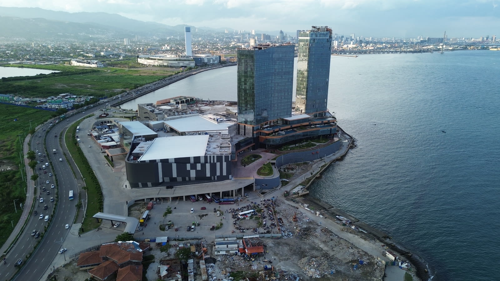 NUSTAR Resort and Casino's towers and SM Seaside City from the air on the South Road Properties, with the sea and Cebu City behind