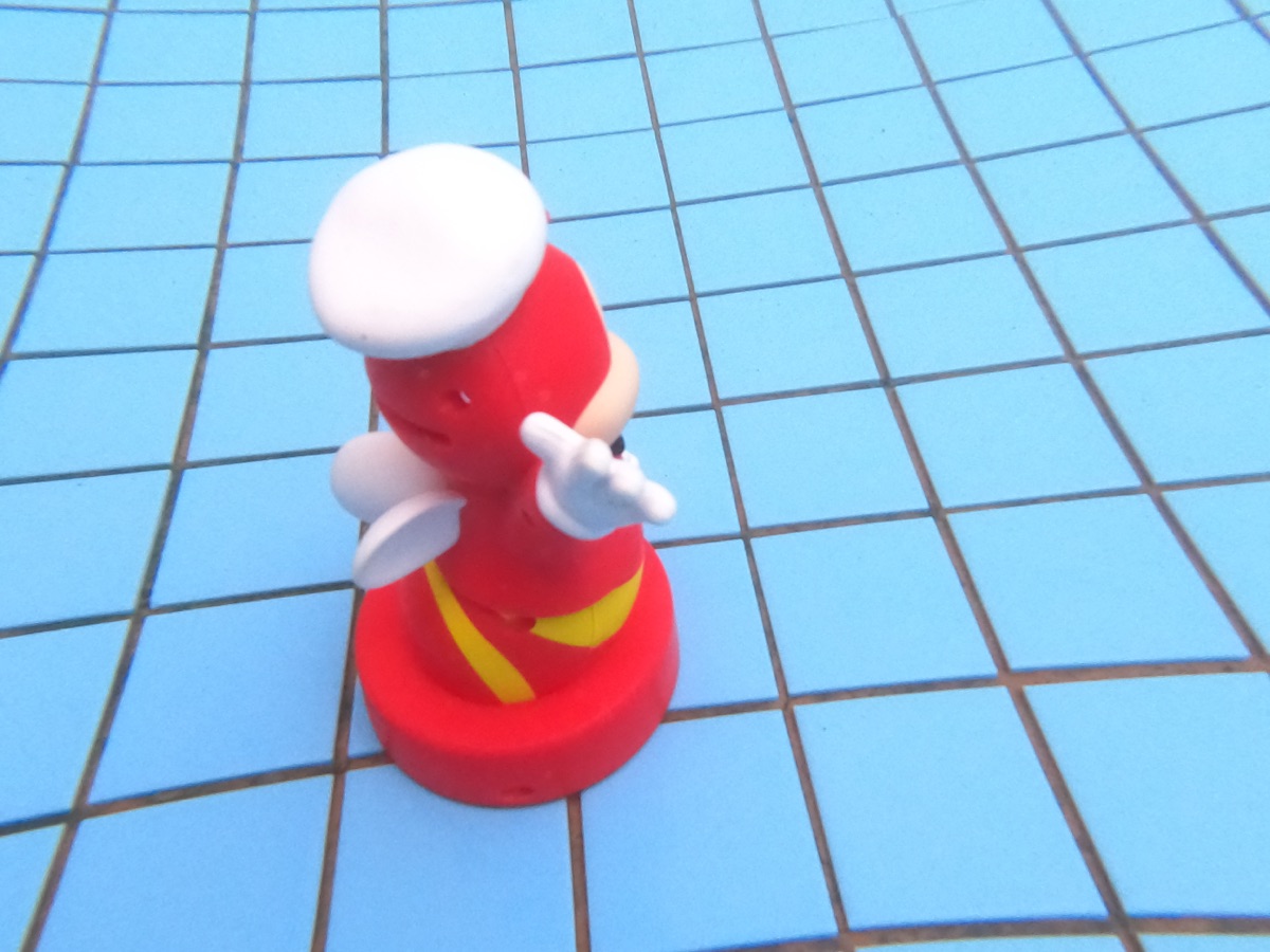 GoPro photo of a Jollibee figurine on the blue-tiled floor of a pool