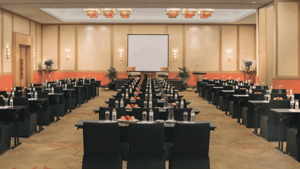 Crimson Resort and Spa Mactan ballroom set with rows of tables facing a projection screen