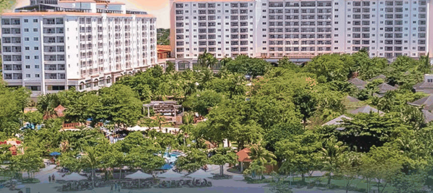 Jpark Island Resort hotel towers above tropical gardens and the beachfront