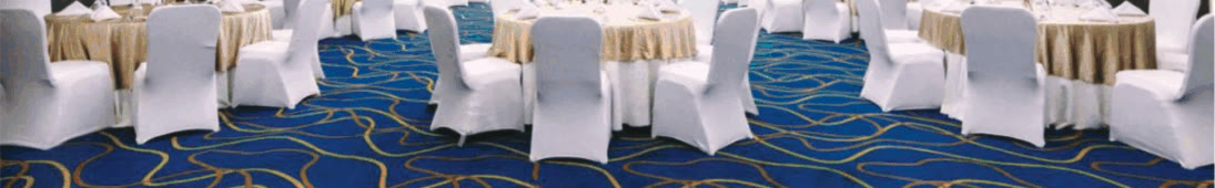 Milan Hall ballroom at Mezzo Hotel with round banquet tables and white-covered chairs