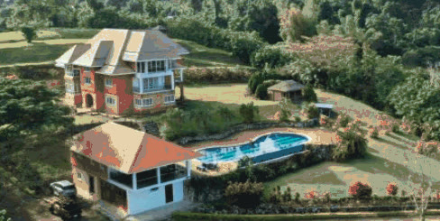 Aerial view of red-roofed villas and a pool at The Dales and Terracota Manor