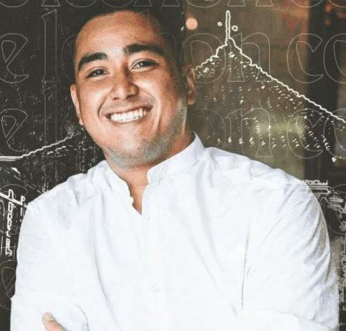 Smiling chef in a white shirt with arms crossed, The Lechon Co.