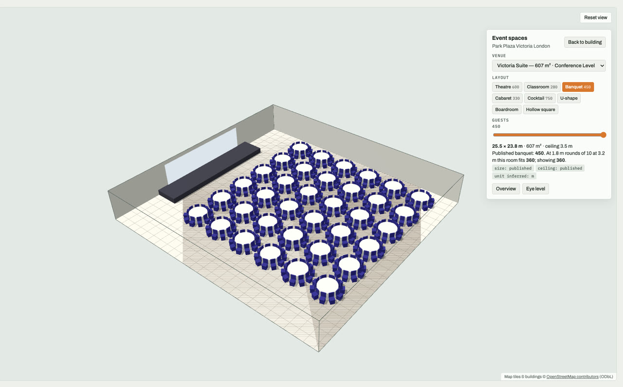 Victoria Suite at Park Plaza Victoria London, London, drawn to scale in 3D (26 × 24 m, 607 m², ceiling 3.5 m) and set for a banquet layout of 450 guests: navy chairs around white round tables facing a stage and screen. Event-space model by Budots Media.
