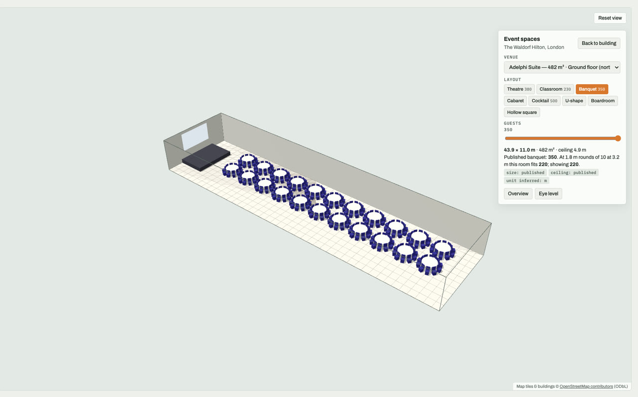 Adelphi Suite at The Waldorf Hilton, London, London, drawn to scale in 3D (44 × 11 m, 482 m², ceiling 4.9 m) and set for a banquet layout of 350 guests: navy chairs around white round tables facing a stage and screen. Event-space model by Budots Media.